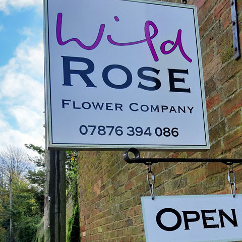 wild rose flower company sign